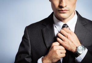 Man getting dressed for work. Businessman in suit and tie.